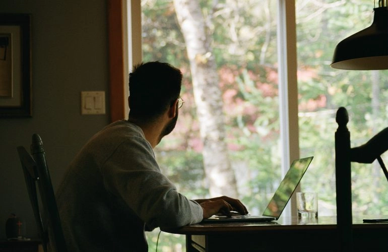 man in gray hoodie using laptop computer